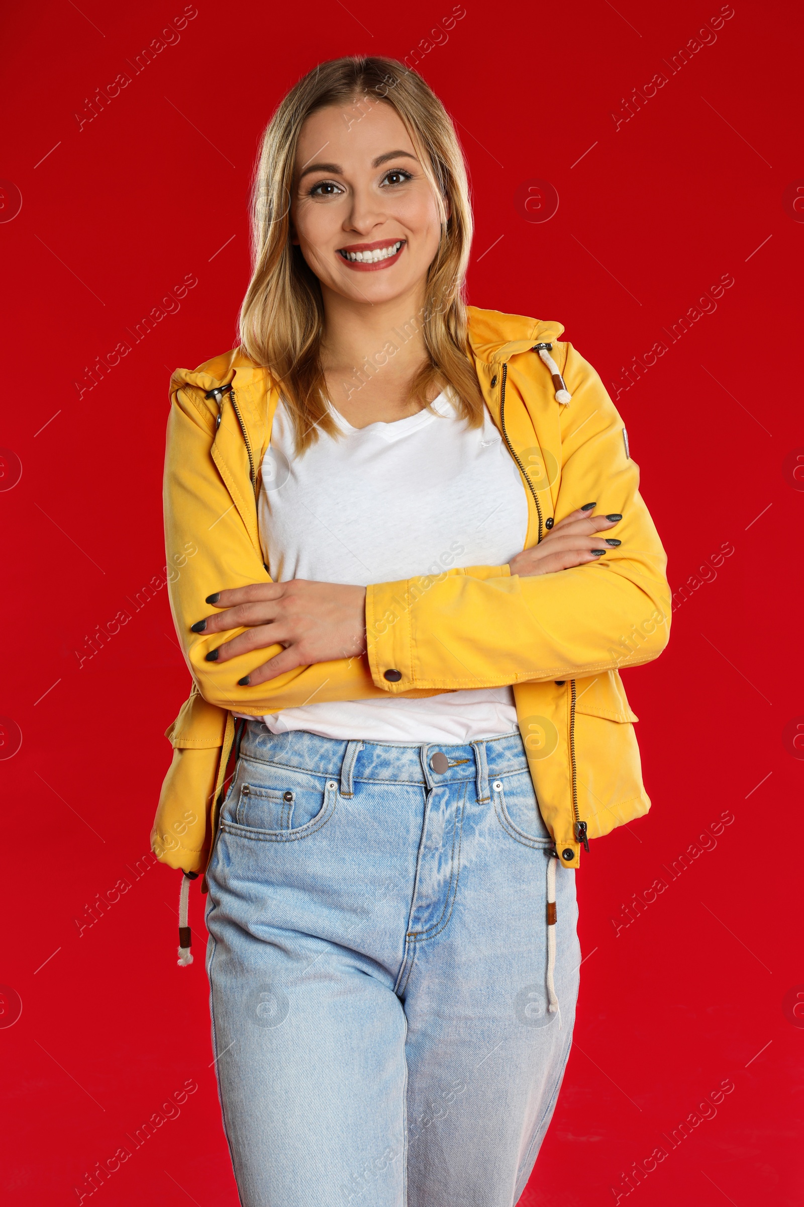 Photo of Beautiful woman in casual outfit on red background