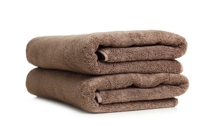 Photo of Folded soft terry towels on white background