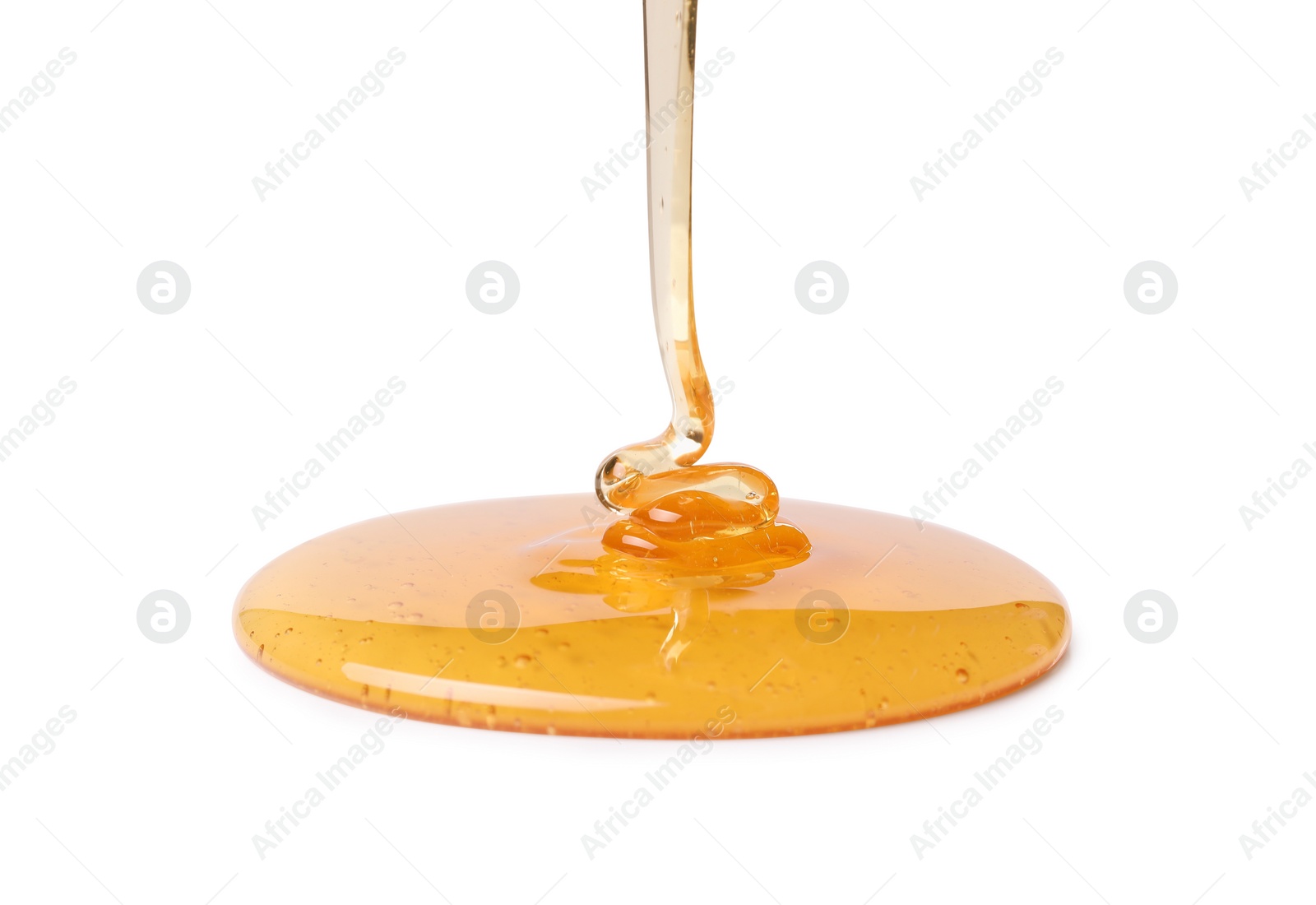 Photo of Pouring tasty natural honey isolated on white