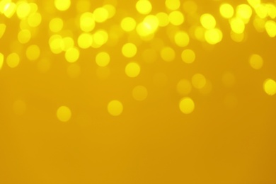 Photo of Blurred view of shiny gold lights. Bokeh effect