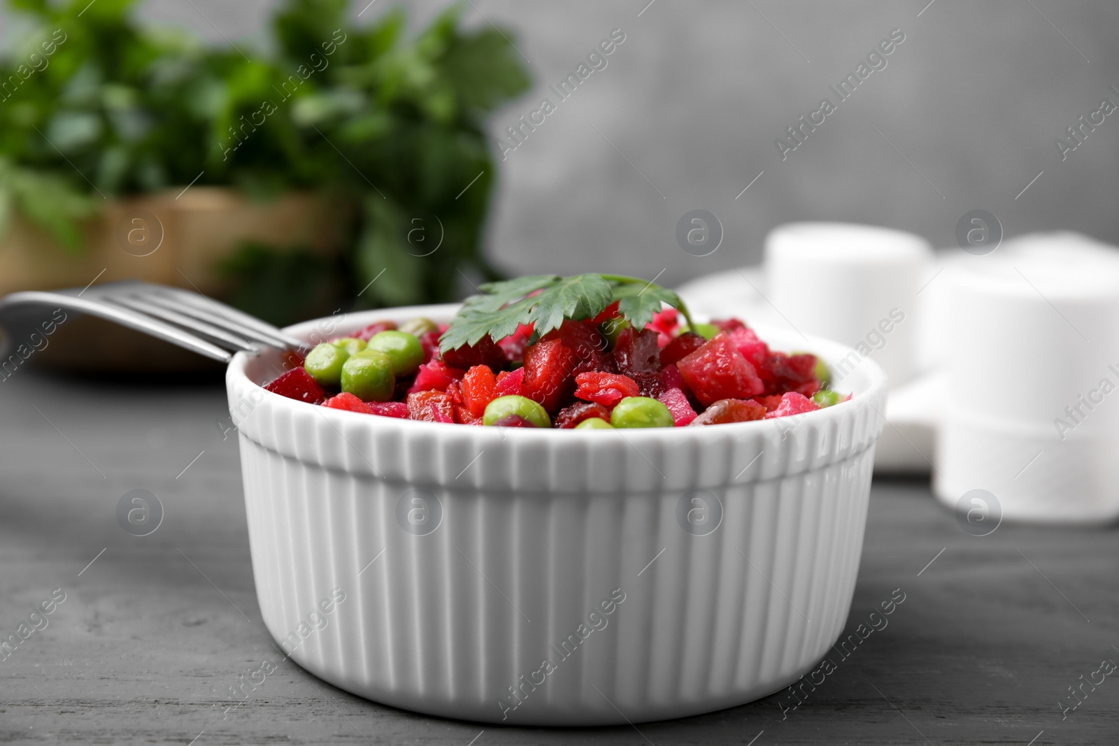 Photo of Delicious vinaigrette salad on grey wooden table, closeup