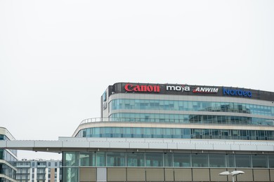 Photo of Warsaw, Poland - September 10, 2022: Building with many modern logos