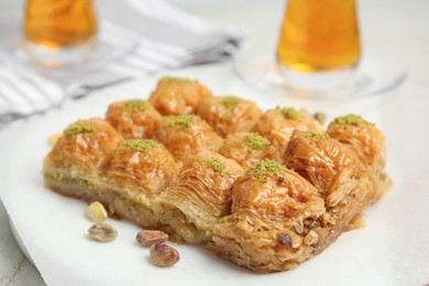 Photo of Delicious sweet baklava with pistachios on table, closeup