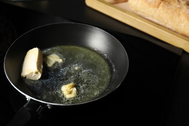 Photo of Melting butter in frying pan on cooktop