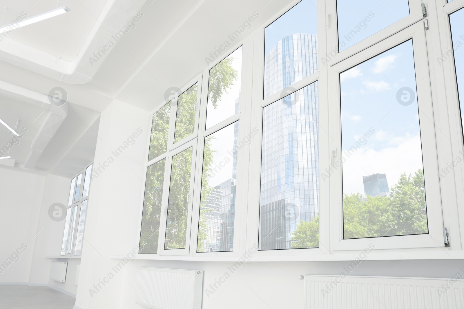 Photo of Empty office room with clean windows and lighting. Interior design