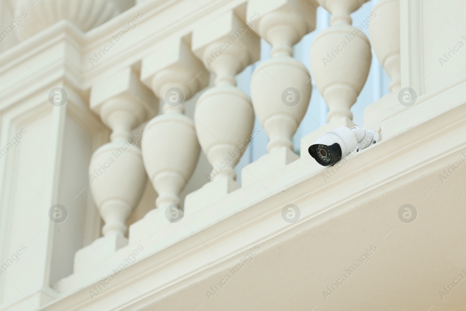 Photo of Modern CCTV security camera on building wall outdoors