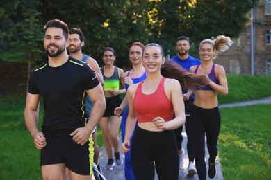 Photo of Group of people running in park. Active lifestyle