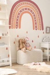 Photo of Child's room interior with rainbow painting on wall