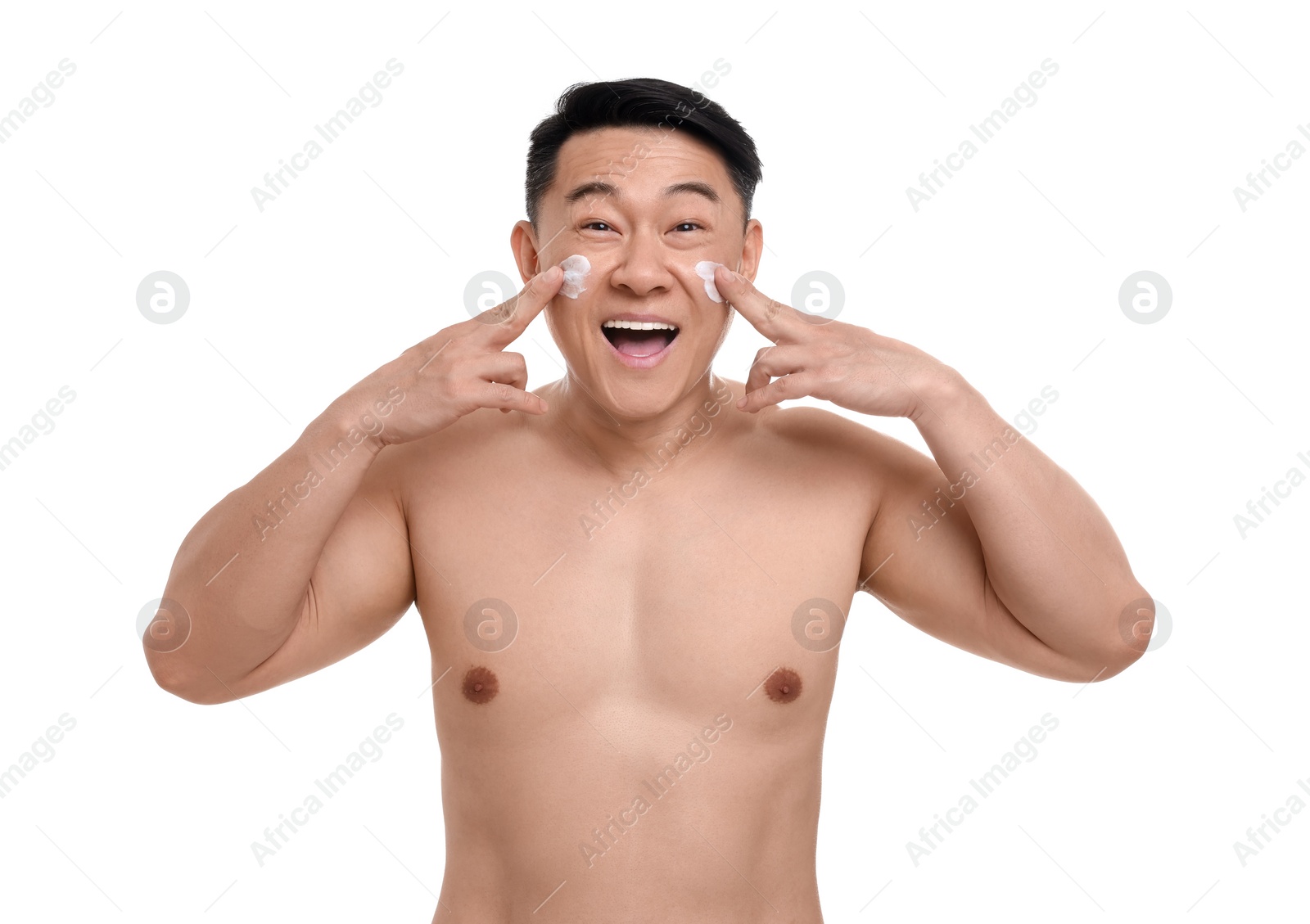 Photo of Emotional man applying cream onto his face on white background