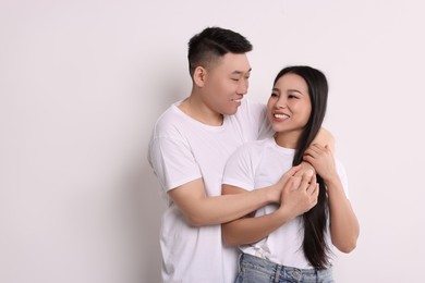 Portrait of happy couple on white background, space for text