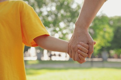 Mature woman with her little grandson in park, closeup