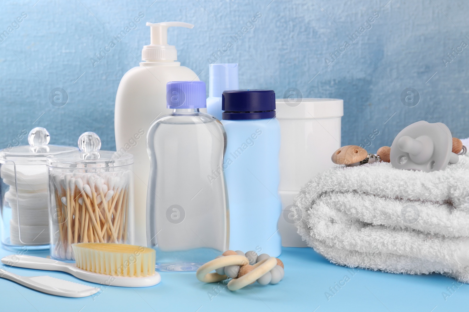 Photo of Baby care products and accessories on light blue table