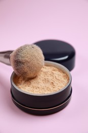 Photo of Face powder and brush on pink background. Decorative cosmetic