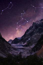 Different constellations in starry sky over mountains at night