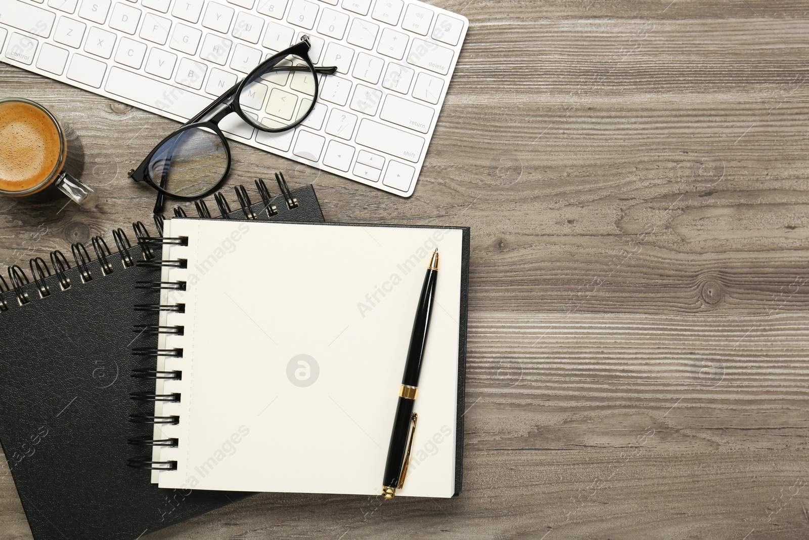 Photo of Flat lay composition with notebooks on wooden table, space for text