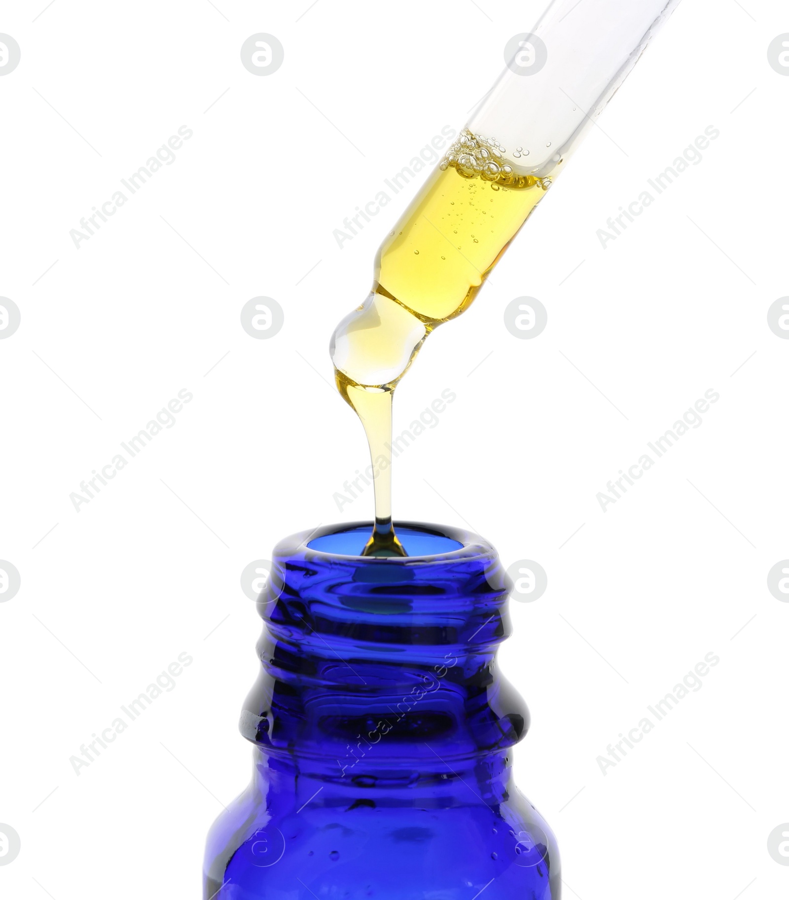 Photo of Dripping tincture from pipette into bottle isolated on white