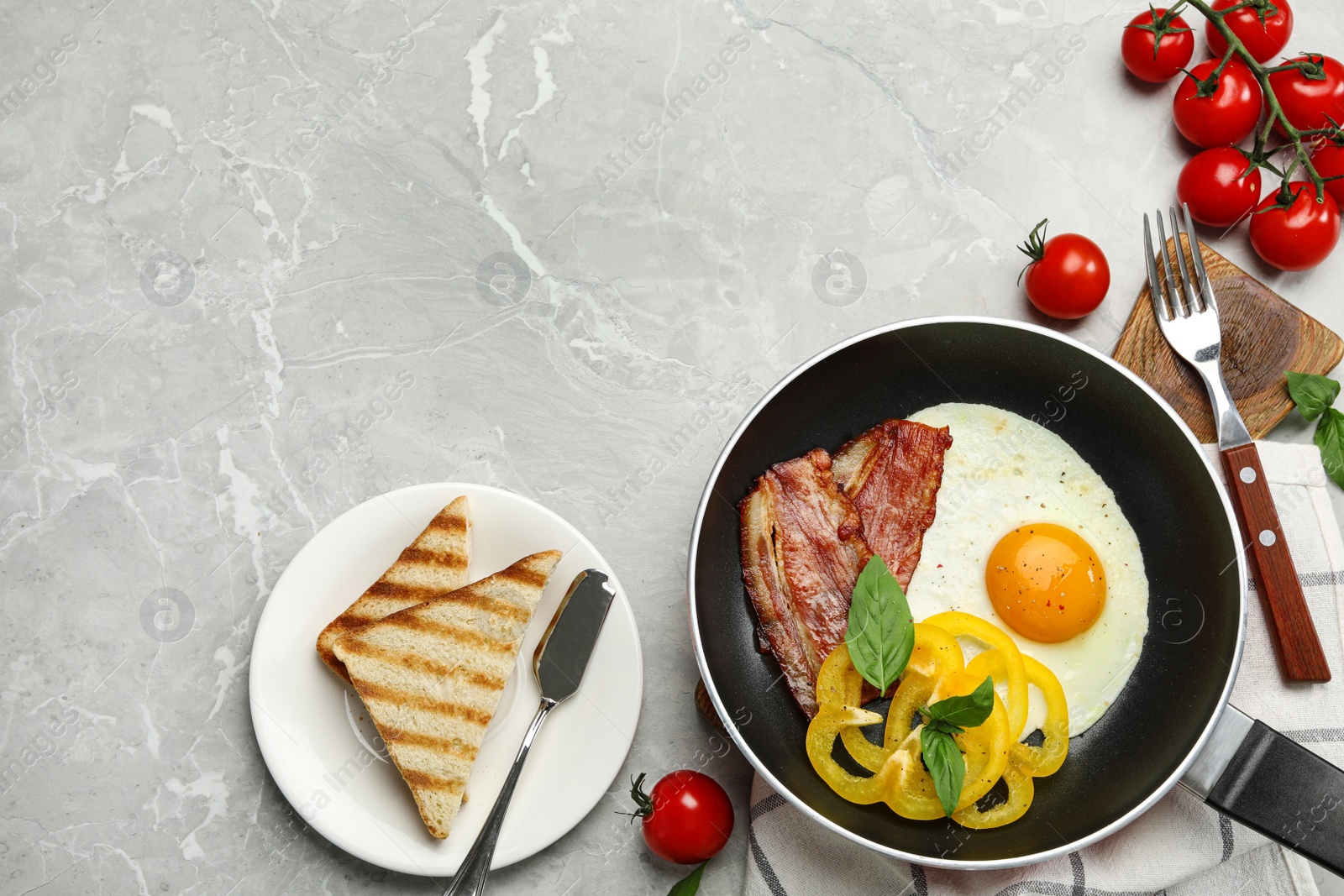 Photo of Tasty breakfast with fried egg on grey marble table, flat lay. Space for text