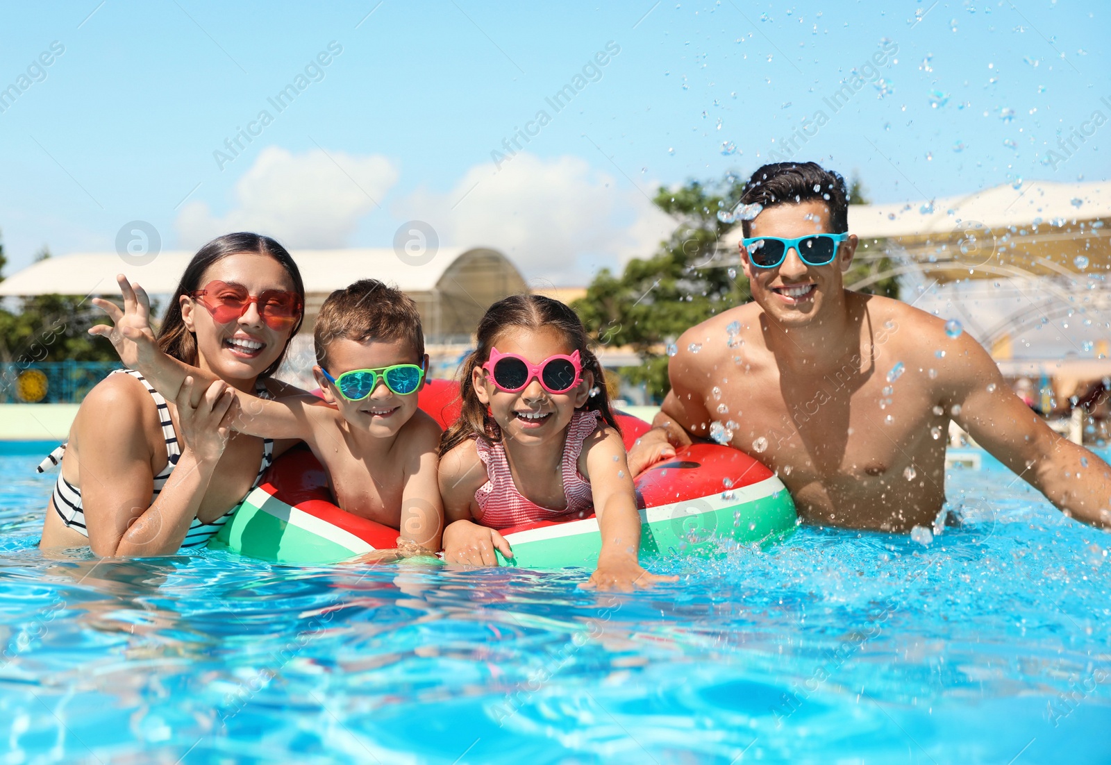 Photo of Happy family in swimming pool. Summer vacation