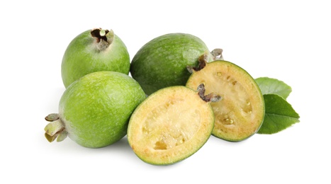 Photo of Whole and cut feijoa fruits on white background