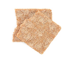 Photo of Pieces of crunchy rye crispbread on white background, top view