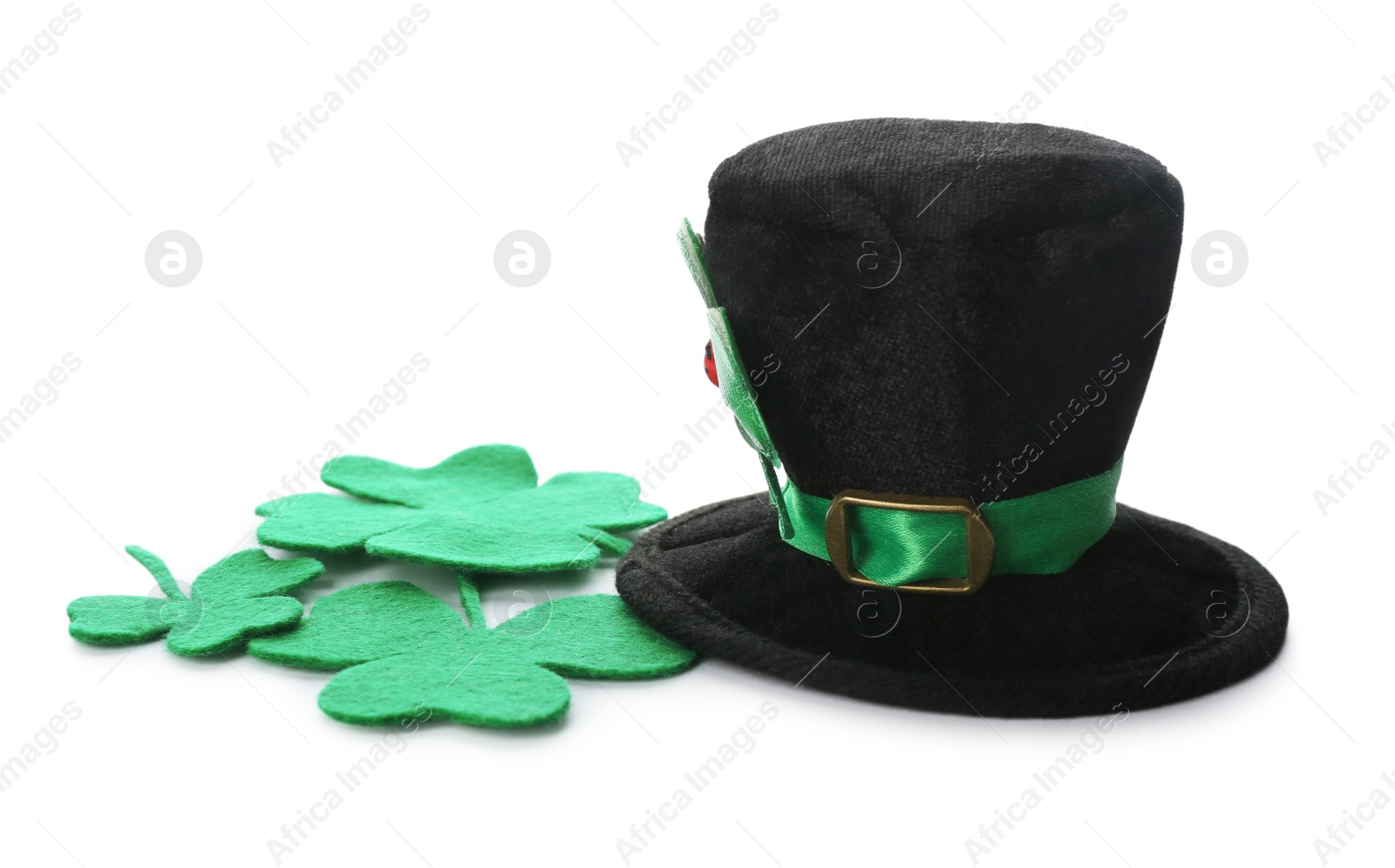 Photo of Leprechaun's hat and decorative clover leaves on white background. St. Patrick's day celebration