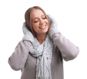 Young woman in warm sweater, mittens and scarf on white background. Winter season