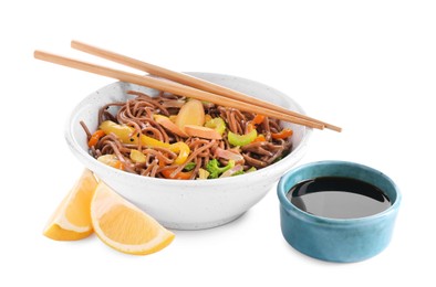 Photo of Stir-fry. Delicious cooked noodles with chicken in bowl, soy sauce, lemon and chopsticks isolated on white