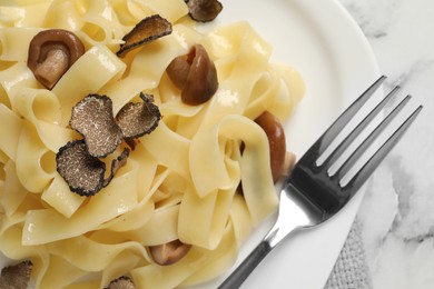 Tasty tagliatelle with truffle on white plate, closeup