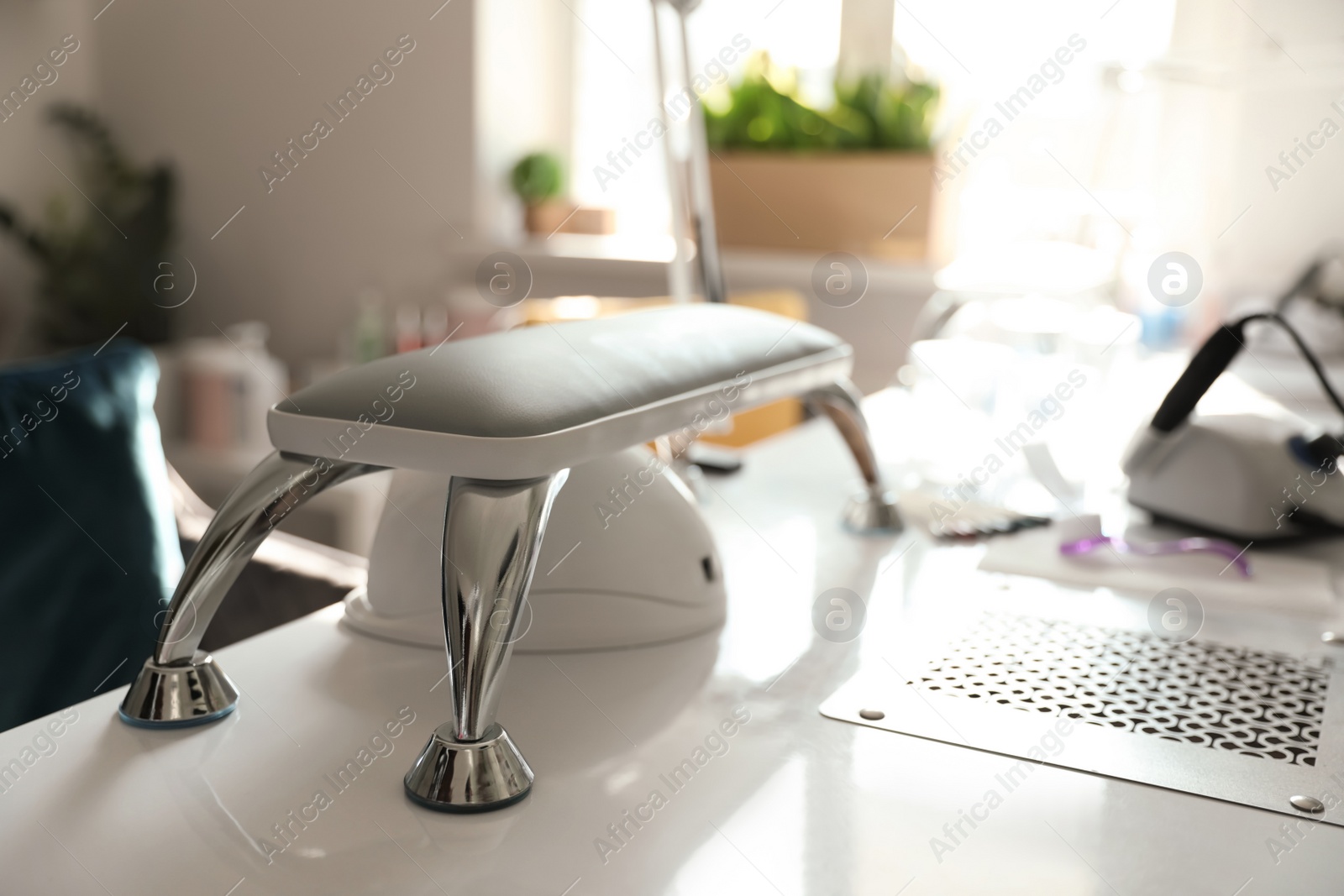 Photo of Professional equipment for manicure on table in beauty salon