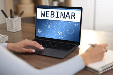 Image of Webinar. Woman using laptop at table, closeup