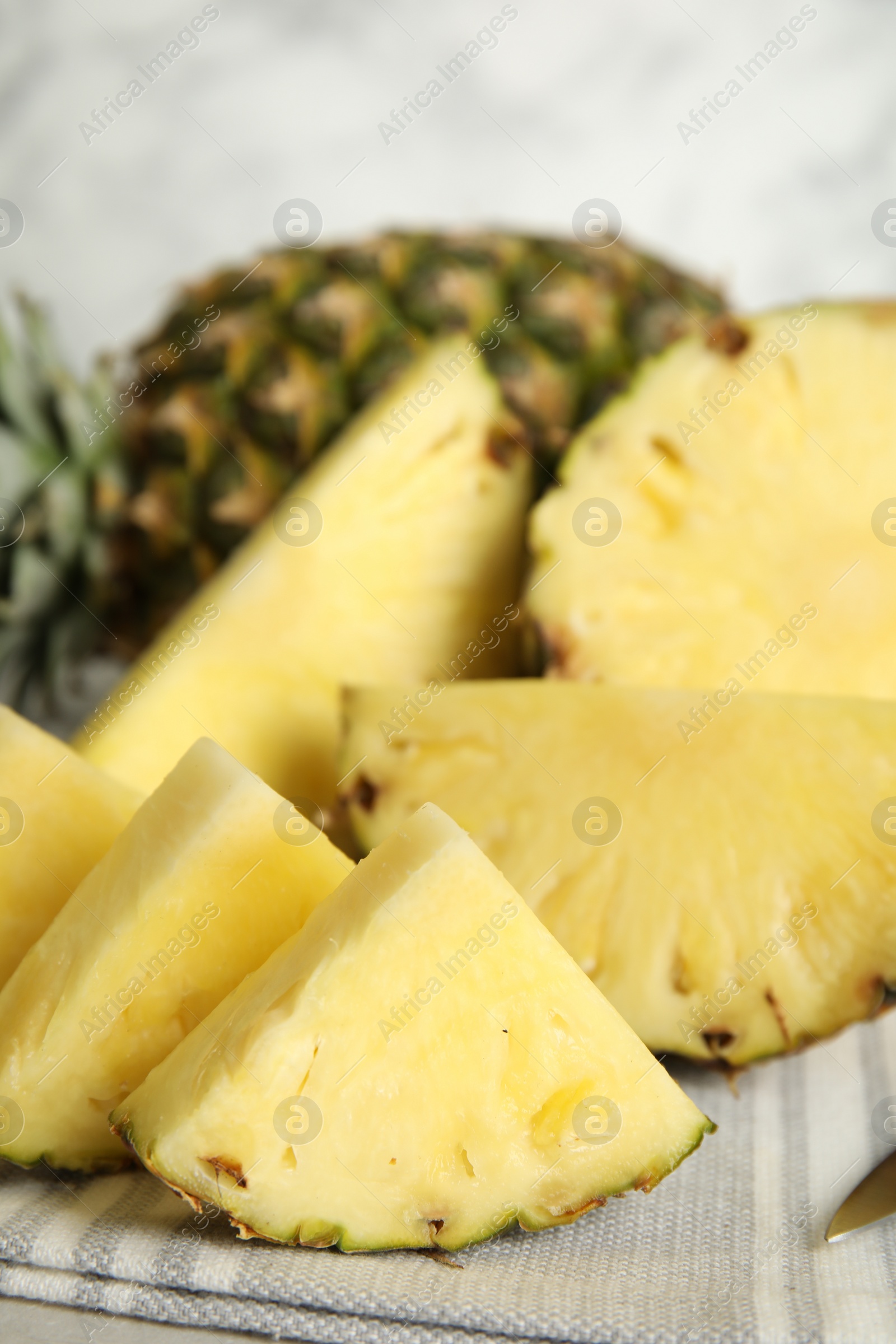 Photo of Slices of fresh juicy pineapple on table, closeup