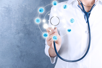 Doctor with stethoscope on blue background, closeup. Medical service