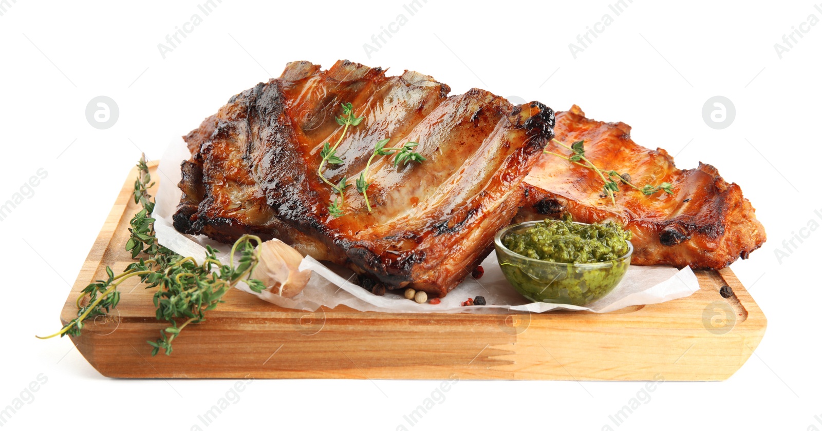Photo of Tasty grilled ribs with sauce isolated on white