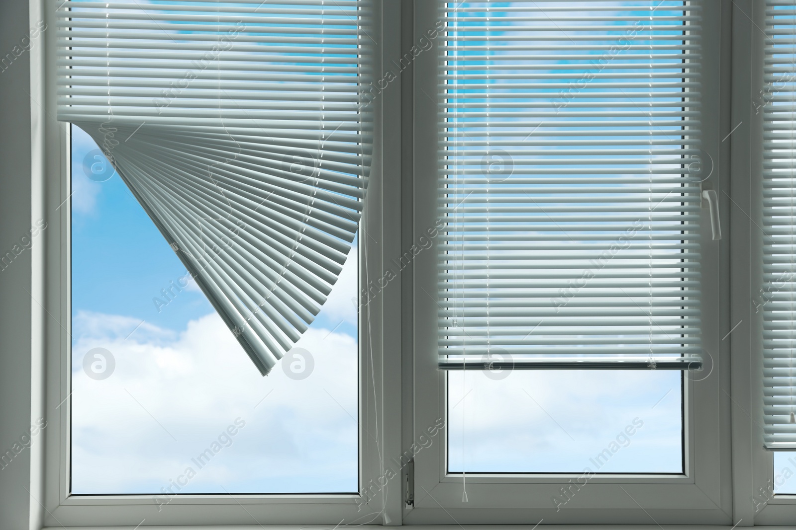 Photo of Stylish window with horizontal blinds in room