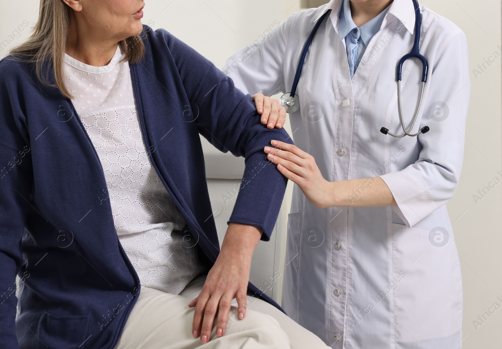 Photo of Arthritis symptoms. Doctor examining patient's elbow in hospital