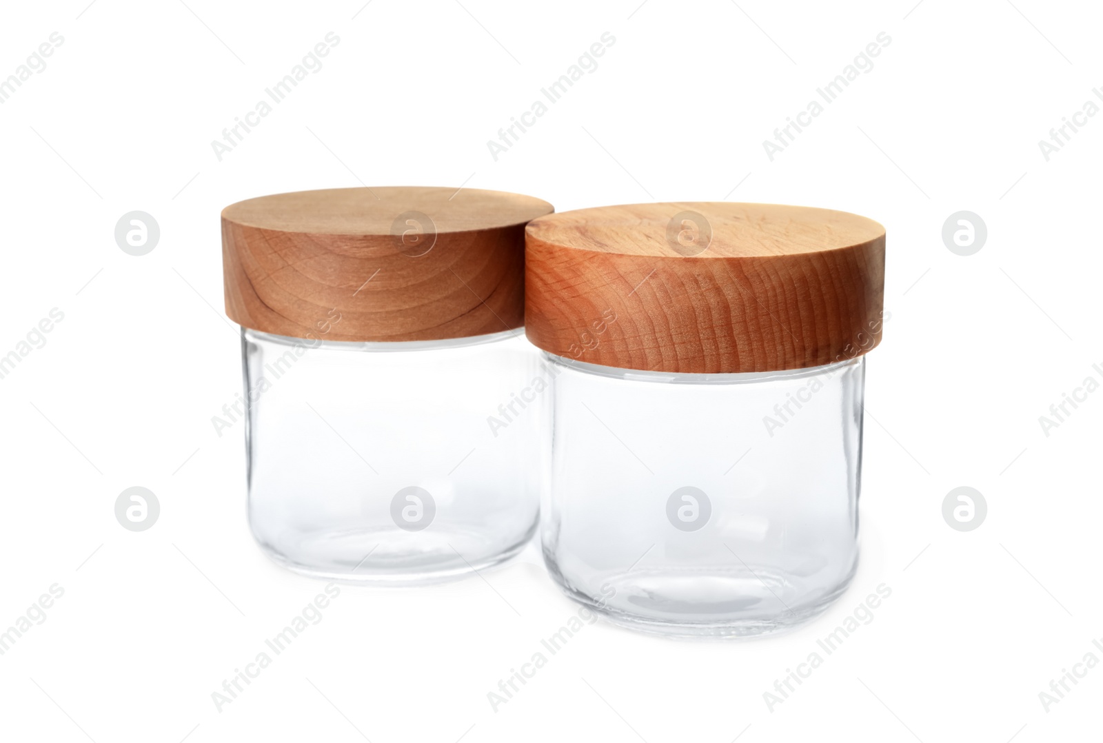 Photo of Two empty glass jars with wooden lids isolated on white