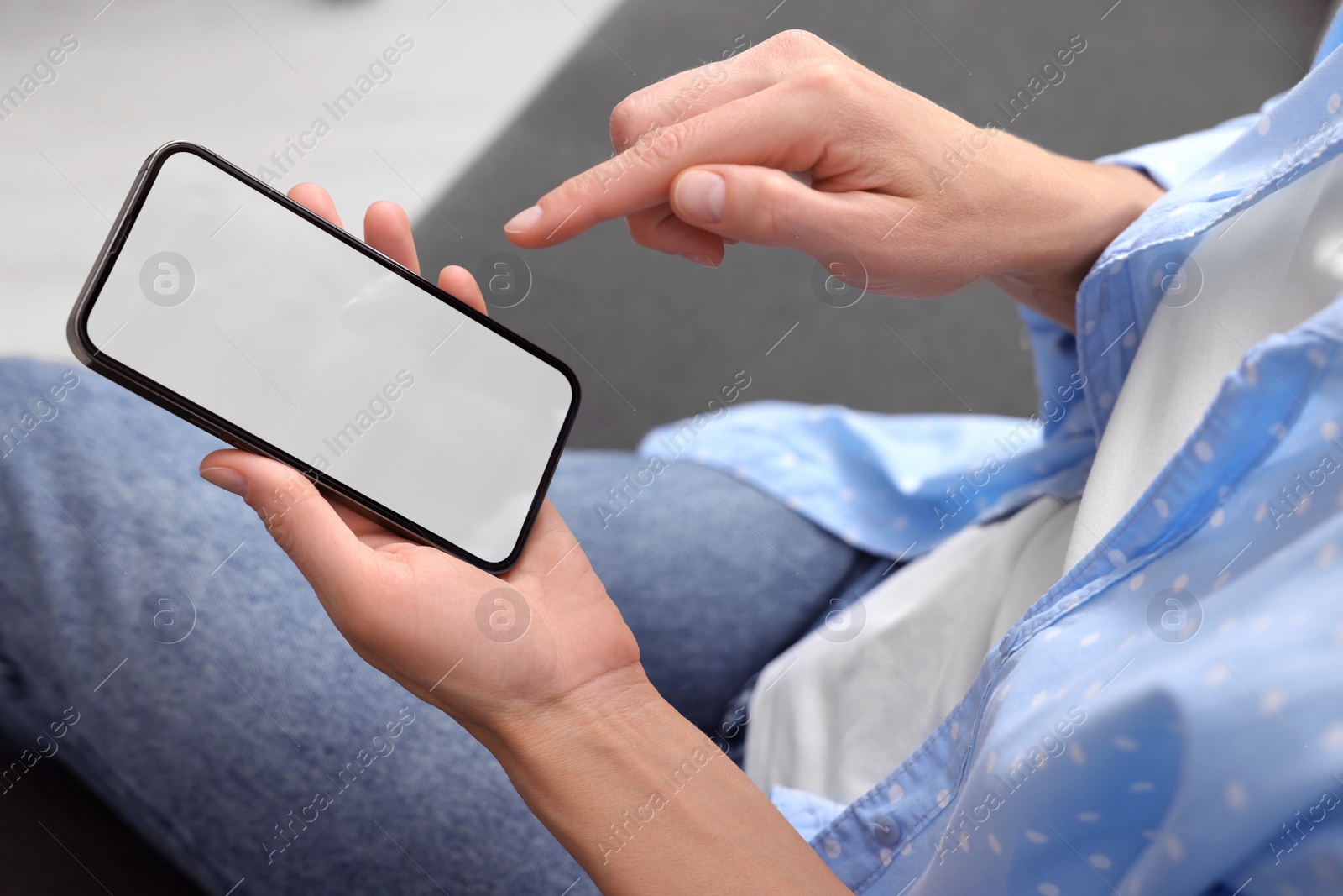 Photo of Woman using smartphone at home, closeup. Space for text