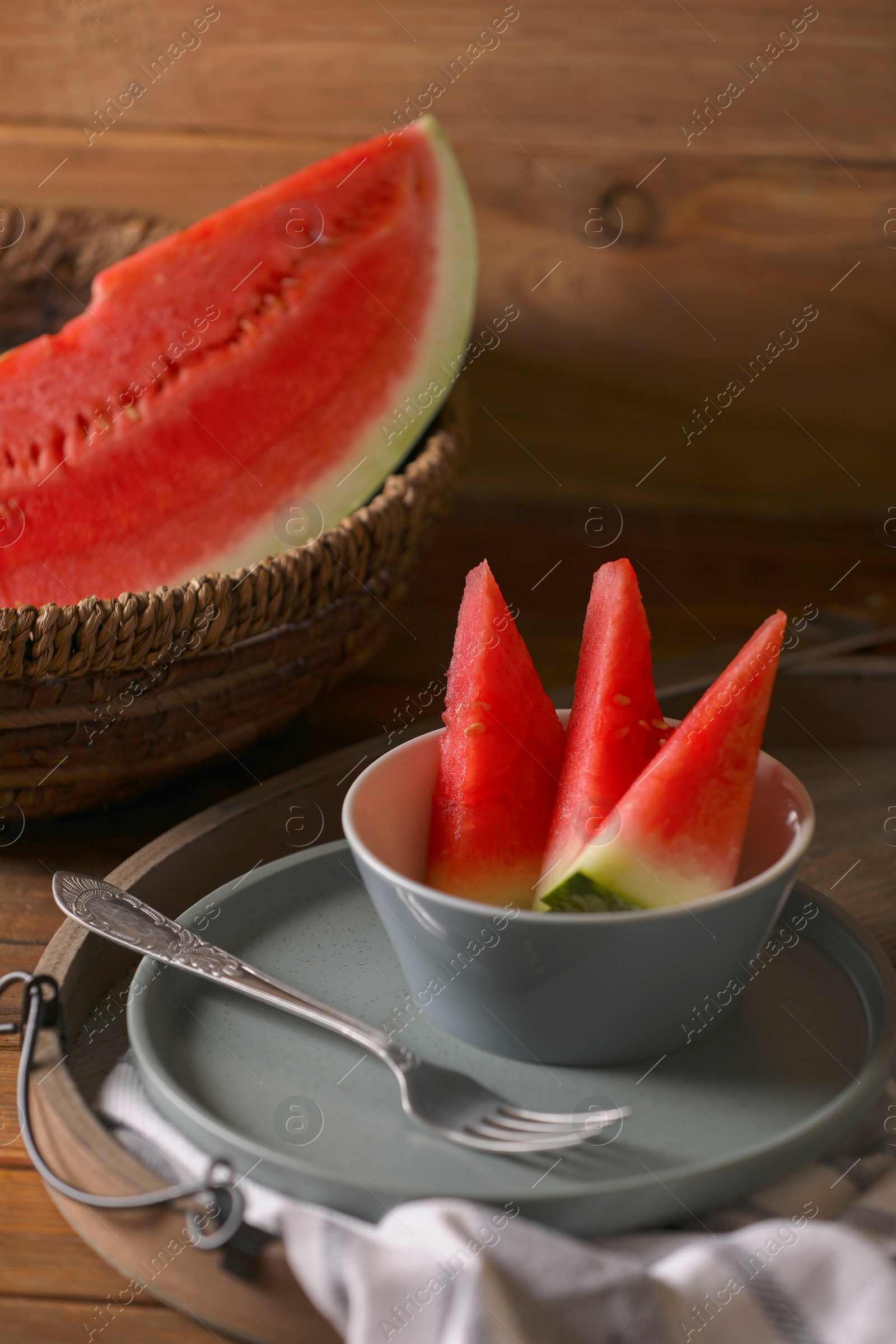 Photo of Fresh juicy watermelon and fork on wooden table