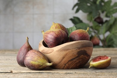 Photo of Many fresh ripe figs on wooden table