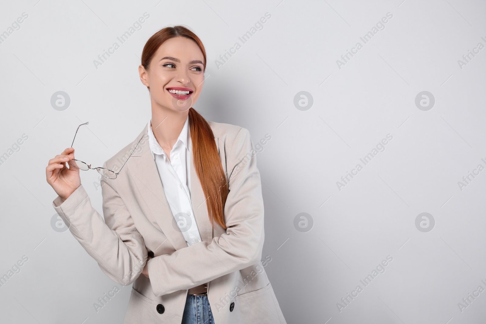 Photo of Portrait of beautiful young woman on light gray background, space for text