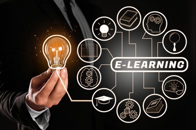Image of E-learning. Man holding lamp bulb on black background, closeup. Illustration of scheme with different icons