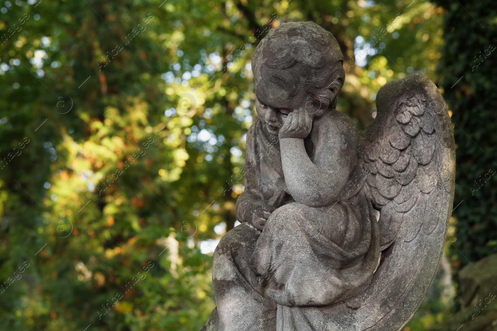 Photo of Beautiful statue of angel at cemetery on sunny day, space for text. Funeral ceremony