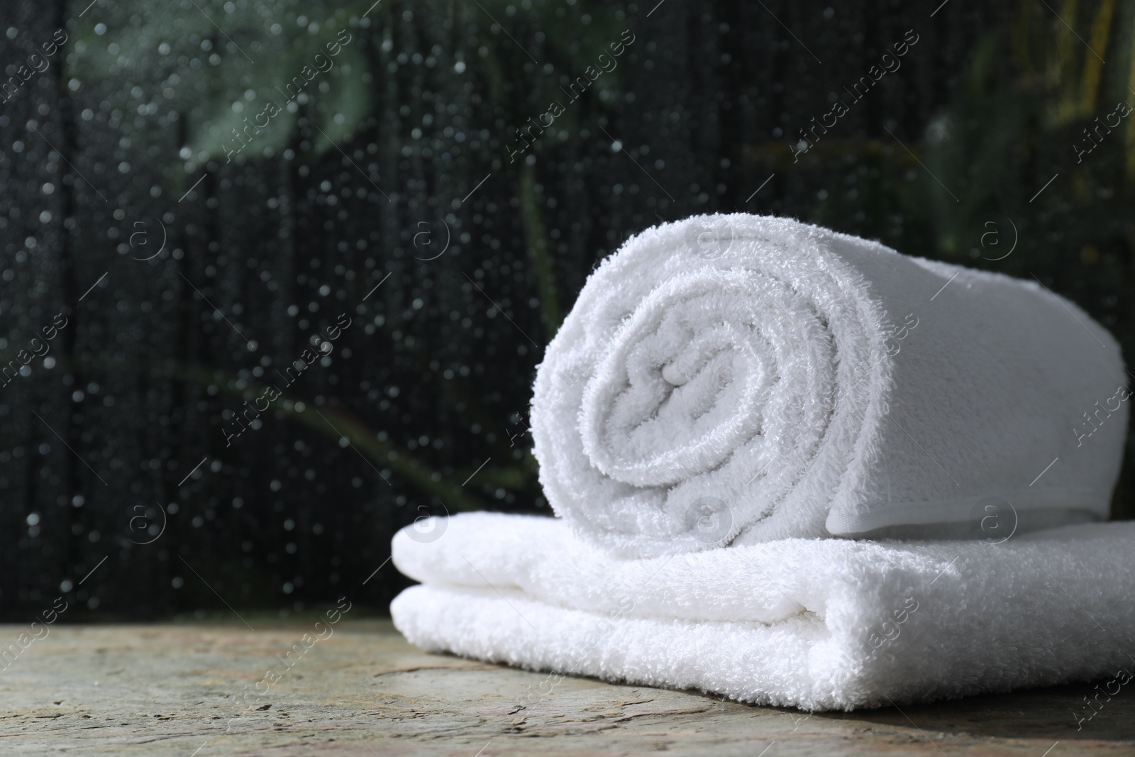 Photo of White terry towels on table in bathroom, space for text