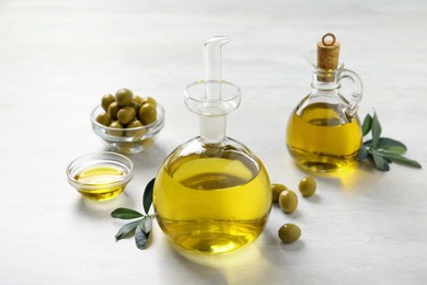 Photo of Bottle of fresh olive oil on white table