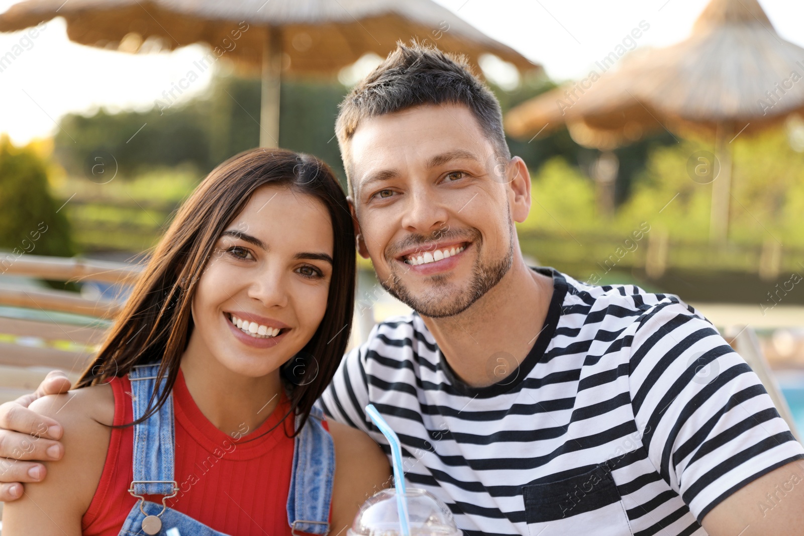 Image of Happy couple resting together outdoors. Summer vacation