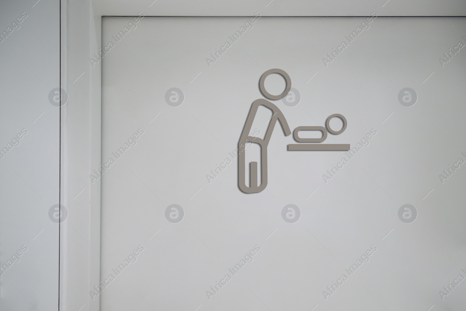 Image of Baby changing station sign on white wall