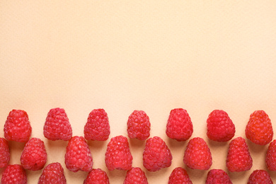 Photo of Fresh sweet ripe raspberries on beige background, flat lay. Space for text