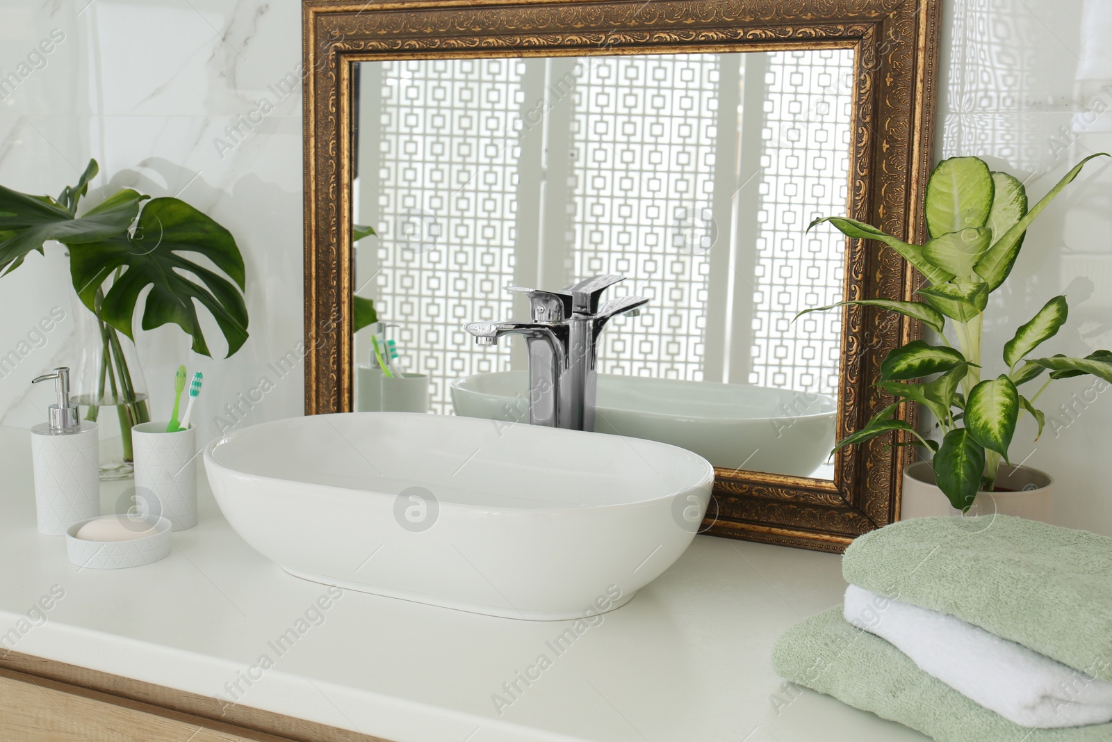 Photo of Vintage mirror and vessel sink in stylish bathroom