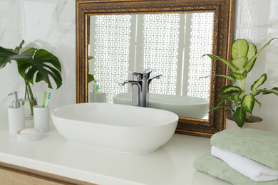 Vintage mirror and vessel sink in stylish bathroom