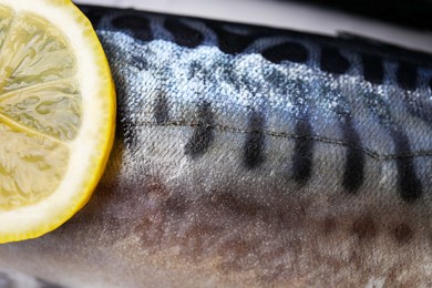 Photo of Tasty raw mackerel with slice of lemon as background, closeup